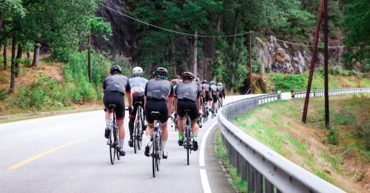 A group of cyclists on a highway as a symbol of team spirit and competition